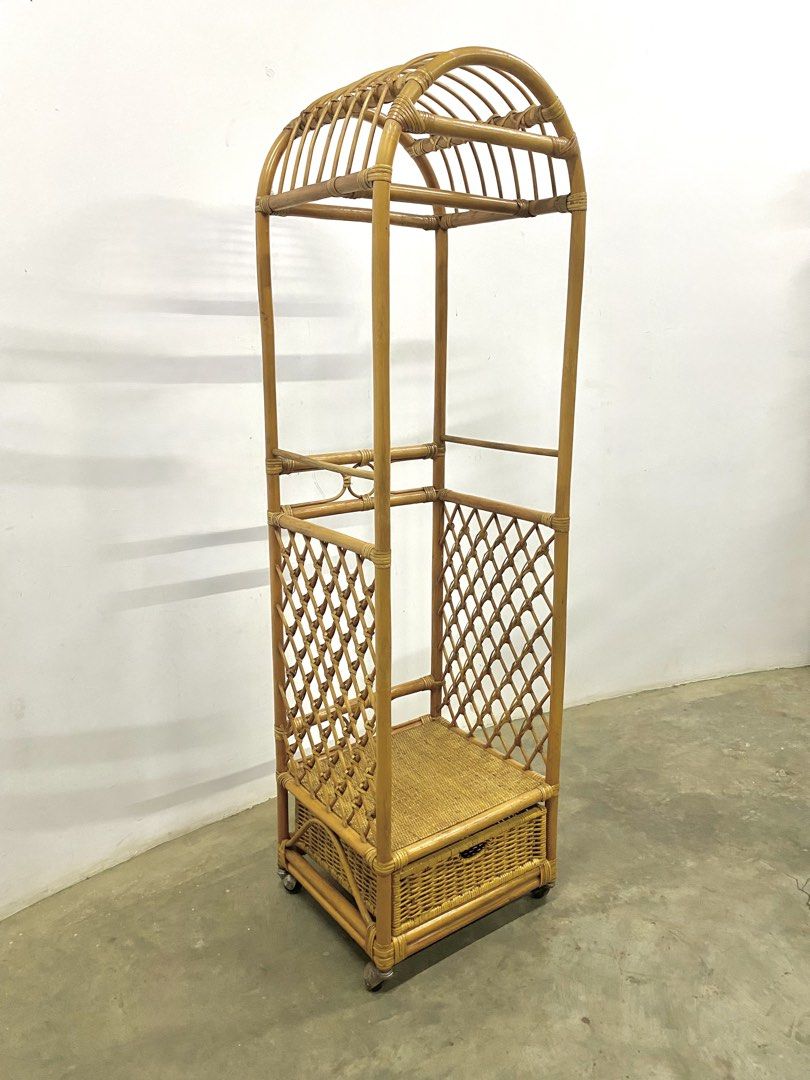 Vintage Rattan Clothes Rack with Drawer (Category: Shelves, Cabinets & Racks) located in Santa Rosa. Submitted by annie_annie83 (Listing ID 1436731880, Image 3). Description: - Vintage rattan clothes rack - Unique arched top design - Built-in drawer for storage - Woven lattice sides - Additional shelf - Mounted on wheels for easy movement - Ideal for bedroom or dressing area.