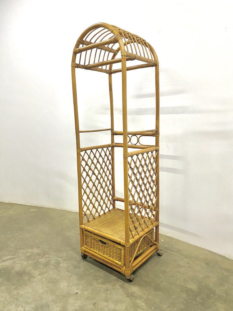 Vintage Rattan Clothes Rack with Drawer (Category: Shelves, Cabinets & Racks) located in Santa Rosa. Submitted by annie_annie83 (Listing ID 1436731880, Image 2). Description: - Vintage rattan clothes rack - Unique arched top design - Built-in drawer for storage - Woven lattice sides - Additional shelf - Mounted on wheels for easy movement - Ideal for bedroom or dressing area.