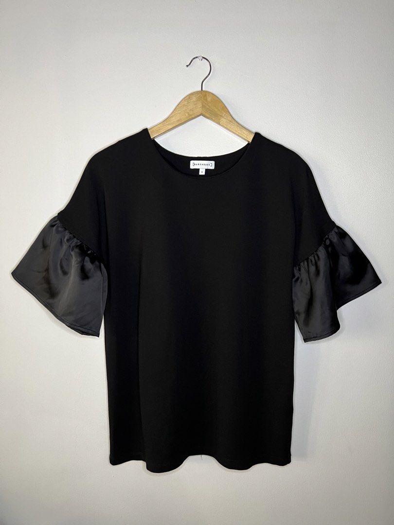 Warehouse Black Top with Ruffle Sleeves (Category: Blouses) located in Quezon City. Submitted by pcera (Listing ID 1436786666, Image 1). Description: - Warehouse black top - Size 10 - Elegant ruffle sleeves - Round neckline - Classic, simple design - Smooth, solid black fabric - Satin-like sleeves.
