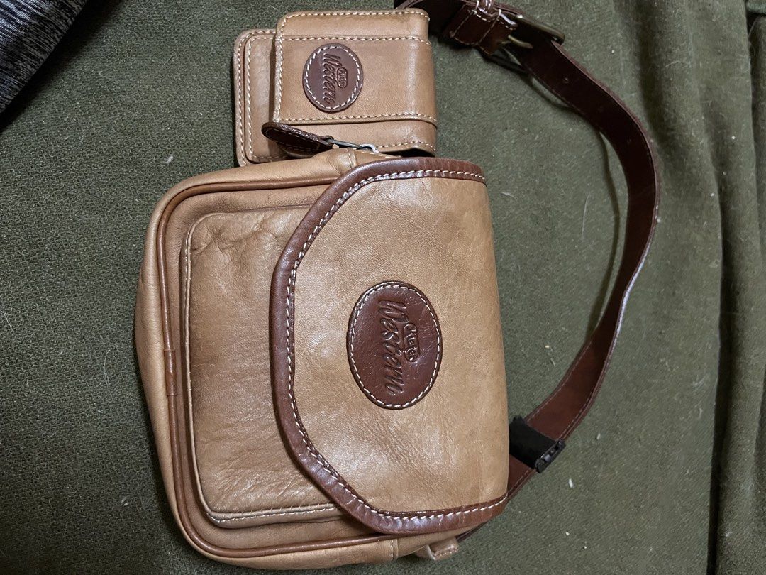 Western Leather Belt Bag (Category: Cross-body Bags) located in Los Banos. Submitted by profemy (Listing ID 1436690926, Image 1). Description: - Brown leather belt bag - Main compartment with flap closure - Attached wallet with velcro closure - Adjustable brown strap - Western logo - Lined with lighter-colored fabric.