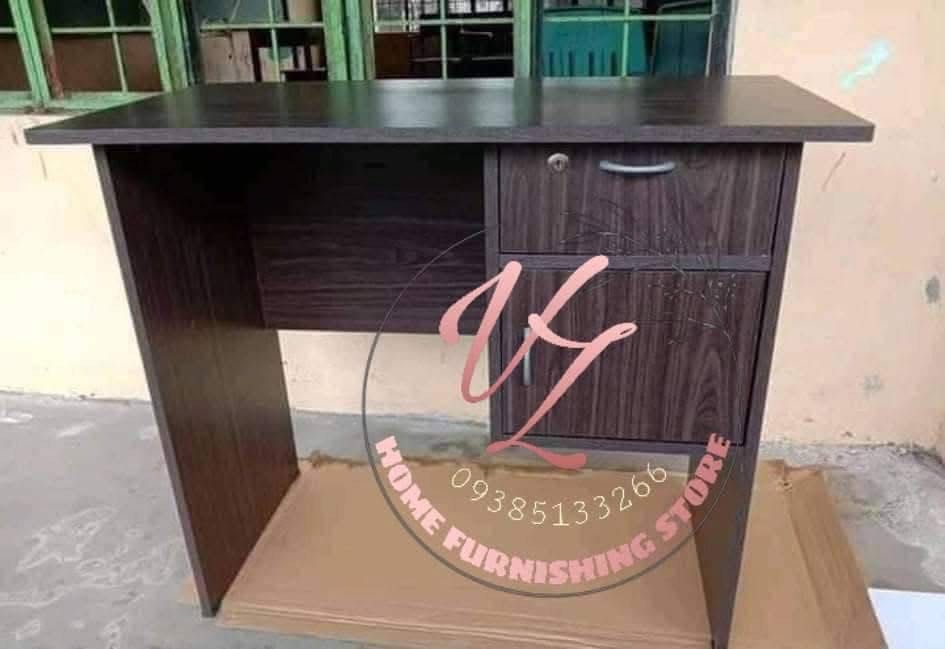 Wooden Office Desk with Drawers (Category: Office Furniture & Fixtures) located in Manila. Submitted by lykcacamacho (Listing ID 1436768920, Image 1). Description: - Durable wooden office desk - Multiple drawers for storage - Lockable top drawer for security - Dark wood grain finish - Sturdy construction - Suitable for home and office use - Simple, functional design.