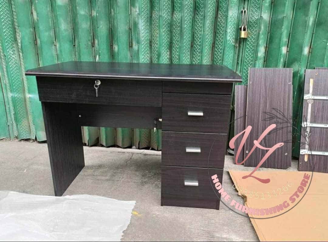 Wooden Office Desk with Drawers (Category: Office Furniture & Fixtures) located in Manila. Submitted by lykcacamacho (Listing ID 1436768920, Image 2). Description: - Durable wooden office desk - Multiple drawers for storage - Lockable top drawer for security - Dark wood grain finish - Sturdy construction - Suitable for home and office use - Simple, functional design.