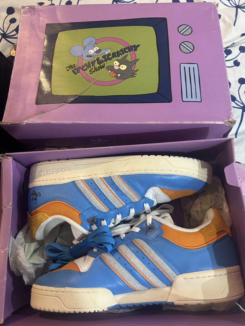 Adidas Simpsons Itchy & Scratchy Shoes (Category: Sneakers) located in Manila. Submitted by ryanolino2 (Listing ID 1436829507, Image 1). Description: - Adidas sneakers inspired by The Simpsons' Itchy & Scratchy Show. - Limited edition - Includes original box with The Simpsons logo, but slightly damaged during transit - Adidas logo on side and sole. - Unworn condition..