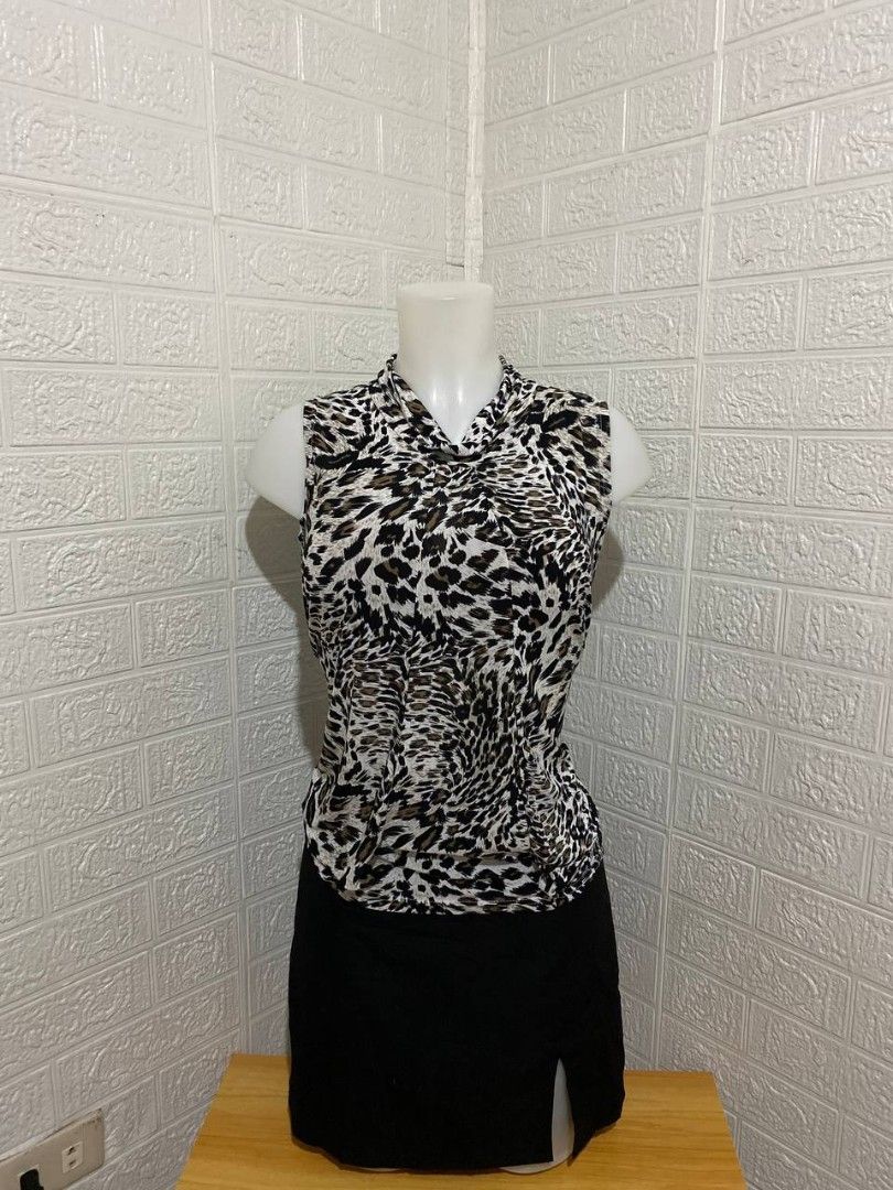 Animal Print Sleeveless Top (Category: Sleeveless) located in Manila. Submitted by leshmode_ig (Listing ID 1436948300, Image 1). Description: - Sleeveless animal print top - Collared neckline - Includes a black skirt - Lightweight fabric - Great for casual and semi-formal events.