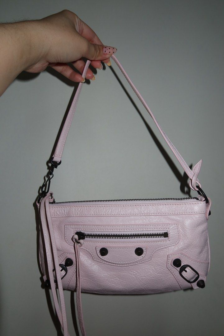 Balenciaga Le City Pouch On Strap (Category: Luxury Bags & Wallets) located in Las Pinas. Submitted by katrenperfar (Listing ID 1436831154, Image 1). Description: - Authentic Balenciaga Le City Pouch On Strap - Color: Petal Pink Features: -With Entrupy Certificate - Zip closure - Exterior zip pocket - Shoulder strap - Interior: Black - Hardware: Black - Material: Textured leather - Includes dust bag - Interior leather brand tag -sourced from Japa