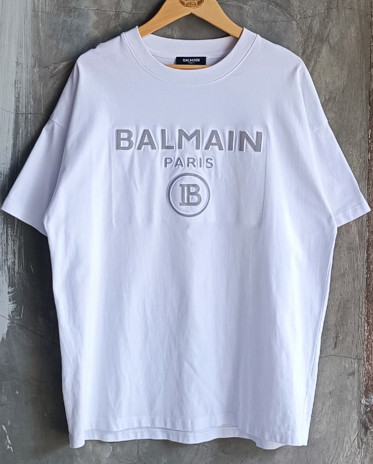 Balmain Paris White T-shirt (Category: Tshirts & Polo Shirts ) located in Guagua. Submitted by retro_finds25 (Listing ID 1436981428, Image 1). Description: Balmain Paris T-shirt - Size: 22 x 27 - Color rate 9/10 - Features the iconic Balmain logo - Made in France - Fabric: 100% cotton - Style: Crew neck, short sleeves - Size: Not indicated.