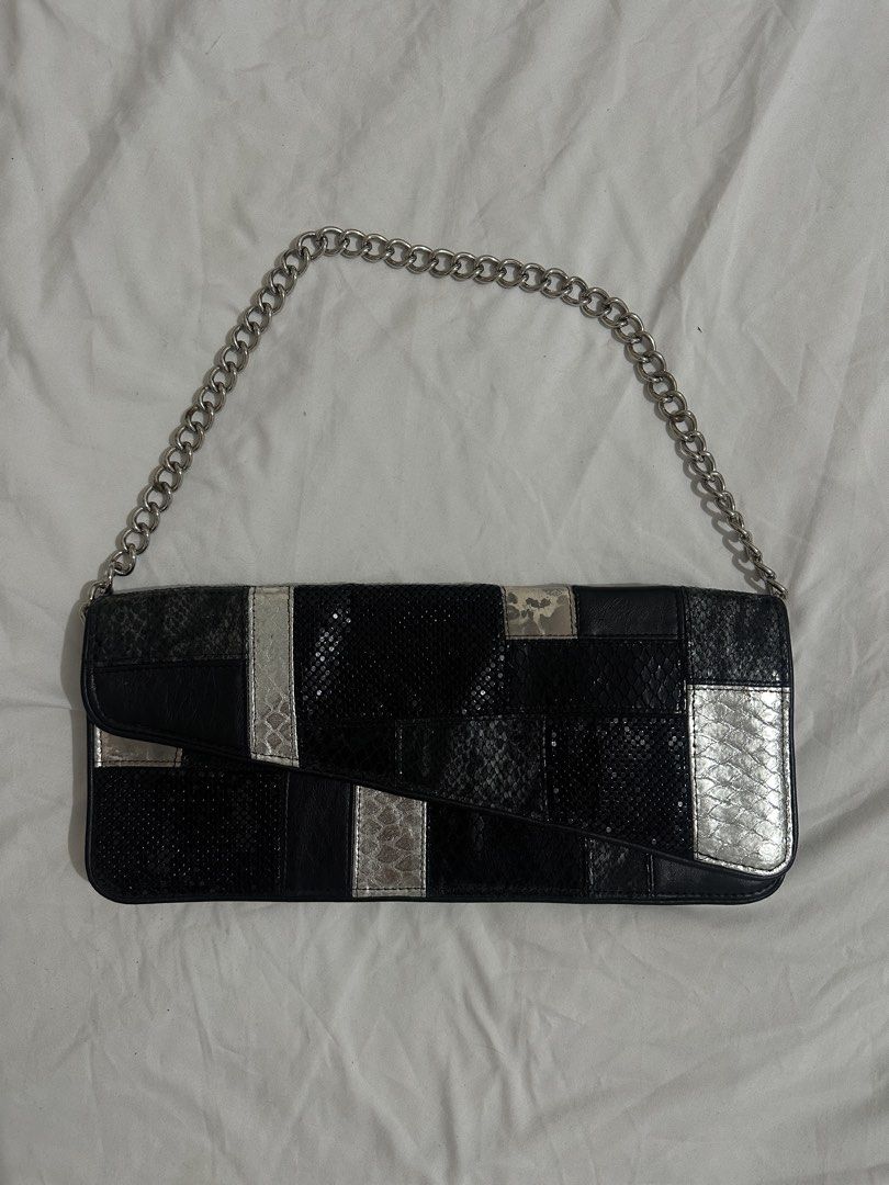 Bebe Black Patchwork Clutch with Chain Strap (Category: Clutches) located in Manila. Submitted by rfibe (Listing ID 1437005214, Image 1). Description: - Bebe patchwork clutch - Black and silver design - Silver chain strap - Zipper closure - Black interior - Bebe logo inside - Perfect for any occasion.