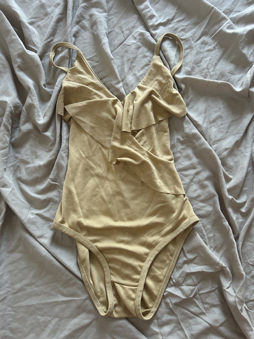 Beige Ruffle Bodysuit (Category: Others Tops) located in Binan City. Submitted by missrandomthings (Listing ID 1436855115, Image 1). Description: - Beige bodysuit - Ruffle detail - Spaghetti straps - Classic cut - Soft, stretchy material - Great for layering.