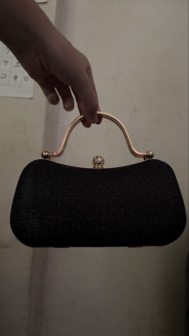 Black Glitter Clutch with Gold Handle (Category: Clutches) located in Makati City. Submitted by chiquitita.collections (Listing ID 1436875741, Image 1). Description: - Black glitter clutch bag - Gold handle and clasp - Decorative jewel accent - Includes gold chain strap - Structured shape - Ideal for formal events.