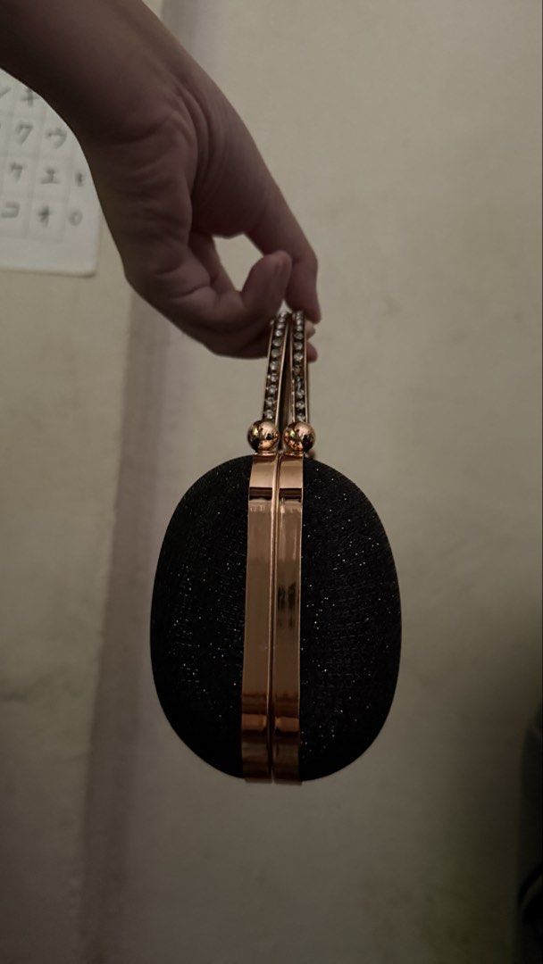 Black Glitter Clutch with Gold Handle (Category: Clutches) located in Makati City. Submitted by chiquitita.collections (Listing ID 1436875741, Image 2). Description: - Black glitter clutch bag - Gold handle and clasp - Decorative jewel accent - Includes gold chain strap - Structured shape - Ideal for formal events.