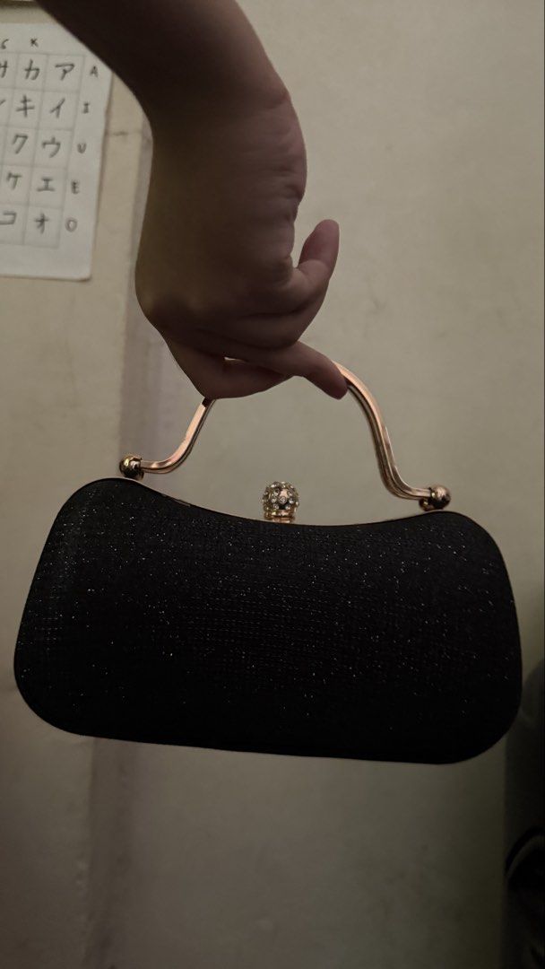 Black Glitter Clutch with Gold Handle (Category: Clutches) located in Makati City. Submitted by chiquitita.collections (Listing ID 1436875741, Image 3). Description: - Black glitter clutch bag - Gold handle and clasp - Decorative jewel accent - Includes gold chain strap - Structured shape - Ideal for formal events.