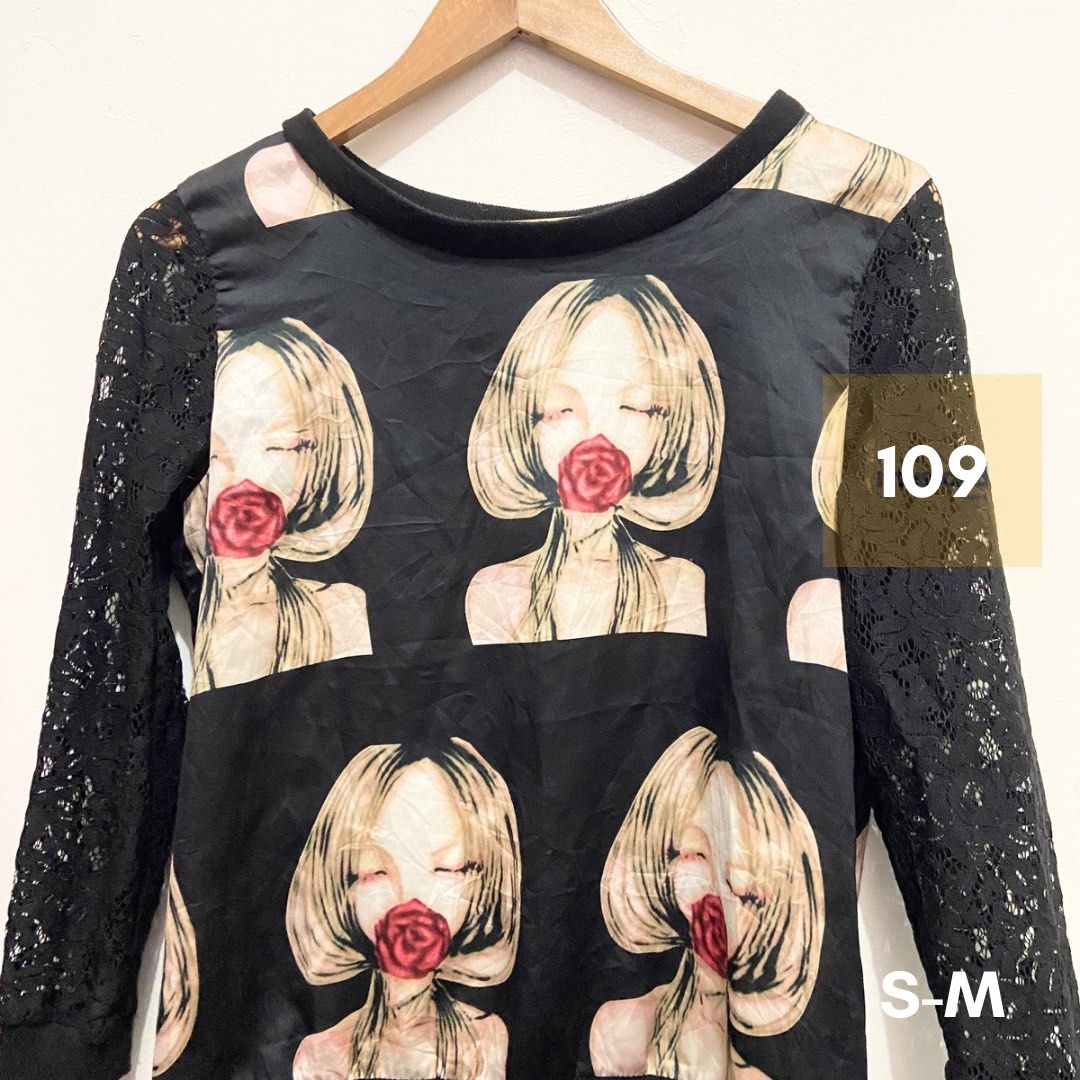 Black Printed Top with Lace Sleeves (Category: Blouses) located in Subic. Submitted by ffe2b9c54b52bc3027a46c5ce117f3 (Listing ID 1436934227, Image 1). Description: - Black top - Unique print: woman with rose - Black lace sleeves - Round neckline - Size: S-M - Stylish design.