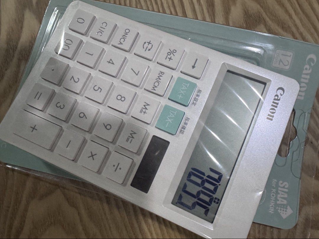 Canon Calculator (Category: Office & Business Technology) located in Manila. Submitted by decluterthings888 (Listing ID 1437016847, Image 3). Description: - White Canon calculator - 12-digit display - Tax calculation buttons - Standard arithmetic functions - Sleek white design with light blue accents - Brand new, in original packaging.