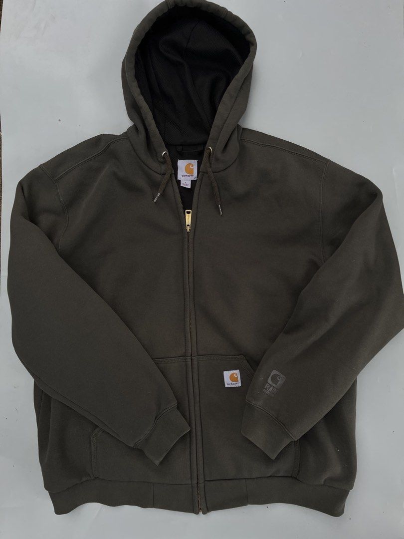 Carhartt Rain Defender Hoodie Jacket - Large (Category: Coats, Jackets and Outerwear) located in Pontevedra. Submitted by thrift01 (Listing ID 1436879653, Image 1). Description: - Carhartt hoodie jacket in olive green - Size: Large Regular - Features: - Full zip - Hood with drawstring - Two front pockets - Rain Defender logo on left sleeve - Interior lining: Dark fabric - Material: 50% cotton, 50% polyester.