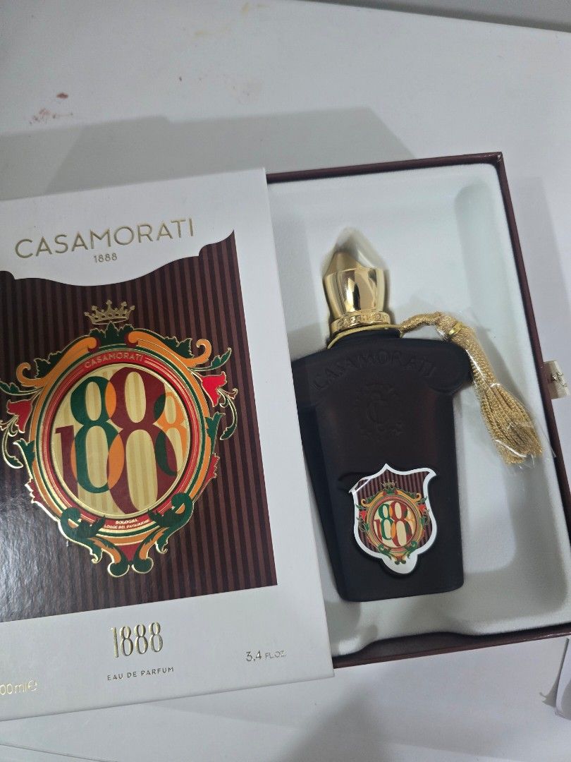 Casamorati 1888 Eau de Parfum 100ml (Category: Fragrance & Deodorants) located in Quezon City. Submitted by thelegallabel (Listing ID 1436849730, Image 1). Description: - Casamorati 1888 Eau de Parfum - 100ml bottle - Dark brown bottle with gold cap and tassel - Comes in original white box with brown and gold emblem - few sprays missing.