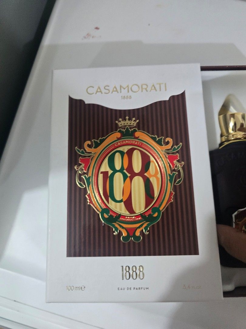 Casamorati 1888 Eau de Parfum 100ml (Category: Fragrance & Deodorants) located in Quezon City. Submitted by thelegallabel (Listing ID 1436849730, Image 2). Description: - Casamorati 1888 Eau de Parfum - 100ml bottle - Dark brown bottle with gold cap and tassel - Comes in original white box with brown and gold emblem - few sprays missing.