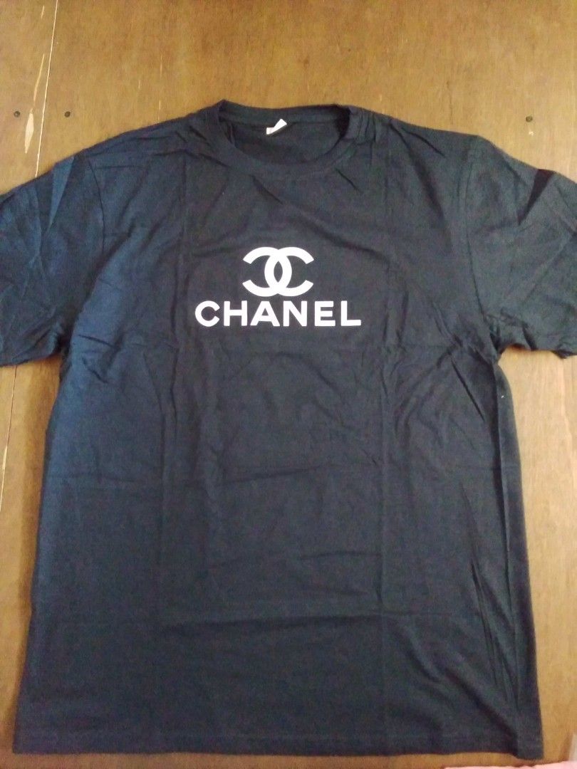 Chanel Black T-shirt (Category: Shirts) located in Bacoor. Submitted by leejay_shop (Listing ID 1436882166, Image 1). Description: - Black Chanel t-shirt - White Chanel logo - Crew neck style - Soft cotton blend fabric - Perfect for casual wear - Simple, classic design.
