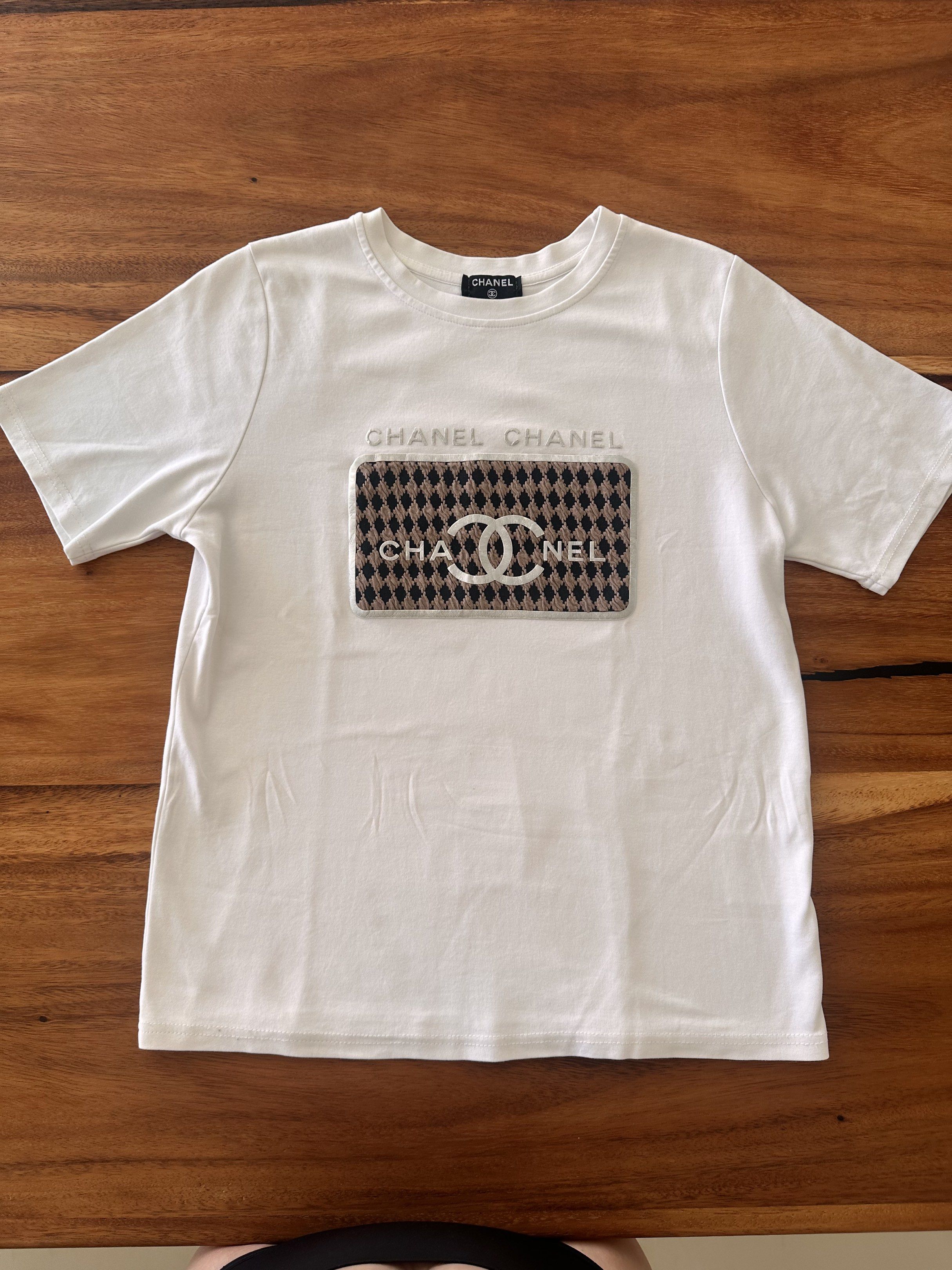 Chanel White T-shirt with Logo (Category: Shirts) located in Cebu City. Submitted by fashionfinds888 (Listing ID 1436830168, Image 1). Description: Authentic Channel White Top with logo , bought in Italy . .