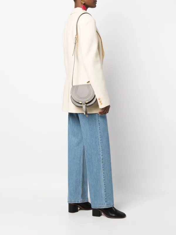 Chloe Marcie MINI Crossbody Bag (Category: Luxury Bags & Wallets) located in Manila. Submitted by decluterthings888 (Listing ID 1436928652, Image 1). Description: - Chloe Marcie Crossbody Bag - Elegant grey color - Classic saddle silhouette - Secure flap closure with gold-tone hardware - Adjustable shoulder strap for comfortable wear - Roomy interior with a convenient slip pocket - Made from luxurious textured leather.