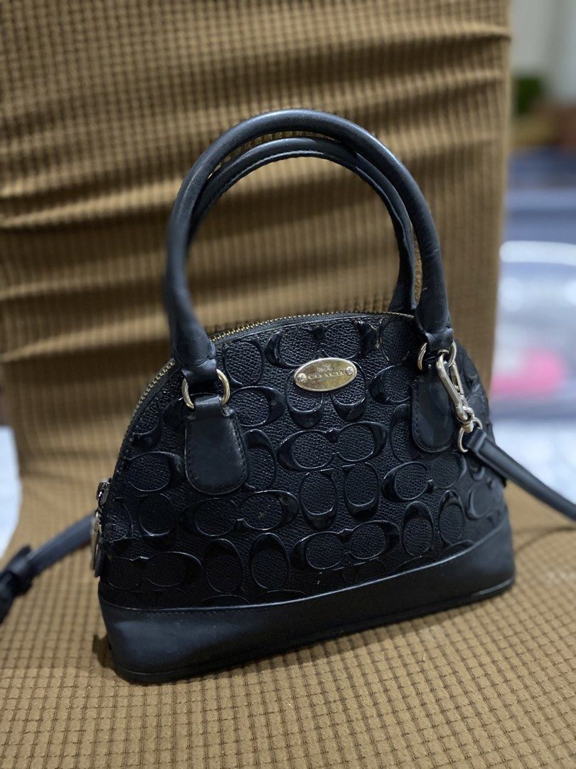 Coach Black Dome Crossbody Bag (Category: Women's Watches) located in Cadiz. Submitted by saveandstyleph (Listing ID 1436993880, Image 2). Description: - Authentic Coach dome crossbody bag - Top handle and detachable crossbody strap - Secure zip closure - Features Coach logo - Silver-toned hardware - Exterior: Repeating Coach logo pattern - Base: Solid black leather.