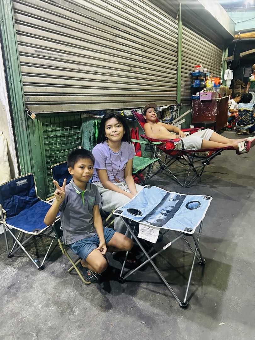 Coleman and Captain Stag Camping Chairs and Table (Category: Hiking & Camping) located in Manila. Submitted by starbalesukandjapansurplus (Listing ID 1436991041, Image 2). Description: Set of camping chairs and a table. Includes various Coleman and Captain Stag chairs in different colors, along with a small folding table with cup holders. Perfect for outdoor activities. The table has a blue surface with a nature-themed design. Some chairs are gre