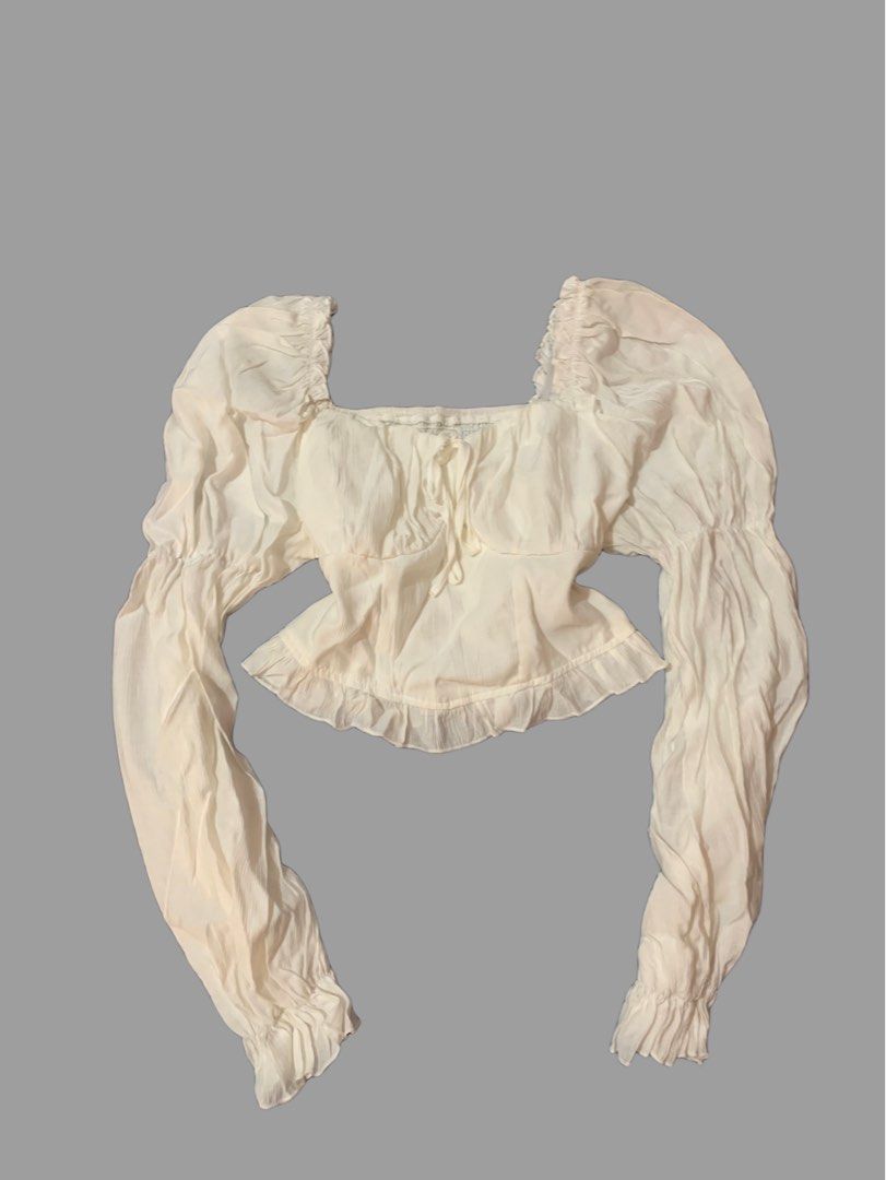 Cream Puff Sleeve Crop Top (Category: Blouses) located in Naga. Submitted by cydie.finds (Listing ID 1437009148, Image 1). Description: SHEIN top for sale 🤍 * Square neckline * Long puff sleeves * Ruffled hem * Tie detail at bust * Shirred back panel * Lightweight textured fabric ✨ Only worn once, still in excellent condition Bought for ₱599, selling for ₱450 Price can still be discussed .