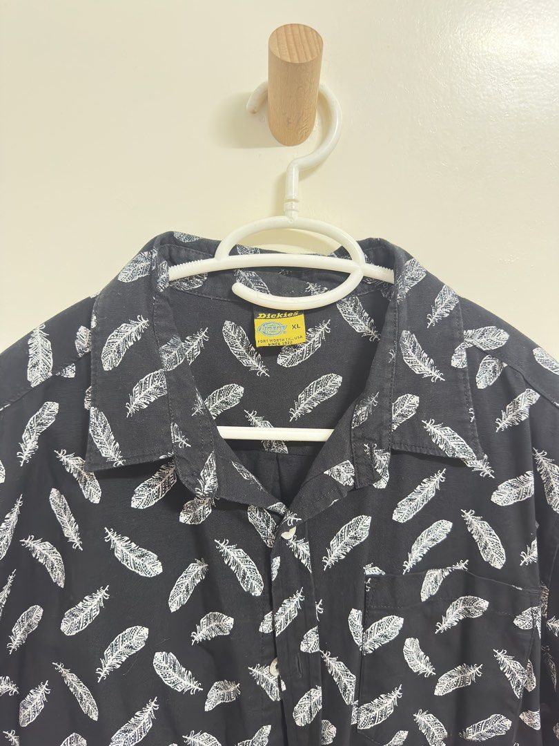 Dickies Feather Print Shirt XL (Category: Tshirts & Polo Shirts ) located in Manila. Submitted by hutfris (Listing ID 1436897285, Image 2). Description: - Dickies short-sleeved shirt - Size: XL - Color: Black with white feather print - Features: Button-down front, chest pocket, collar - Design: Feather print - Condition: Good - Brand: Dickies.