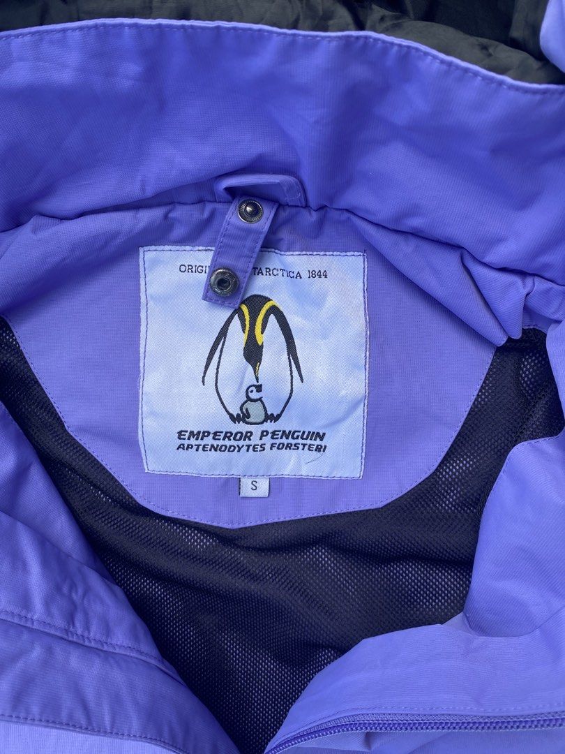 Emperor Penguin Purple Jacket with Hood (Category: Coats, Jackets and Outerwear) located in Manila. Submitted by keenriver-4b36 (Listing ID 1437008716, Image 2). Description: - Emperor Penguin jacket - Size: S - Color: Purple with yellow zipper and pocket accents - Features a hood - Small logo on the chest - Mesh lining inside - Branded ribbon with flags.
