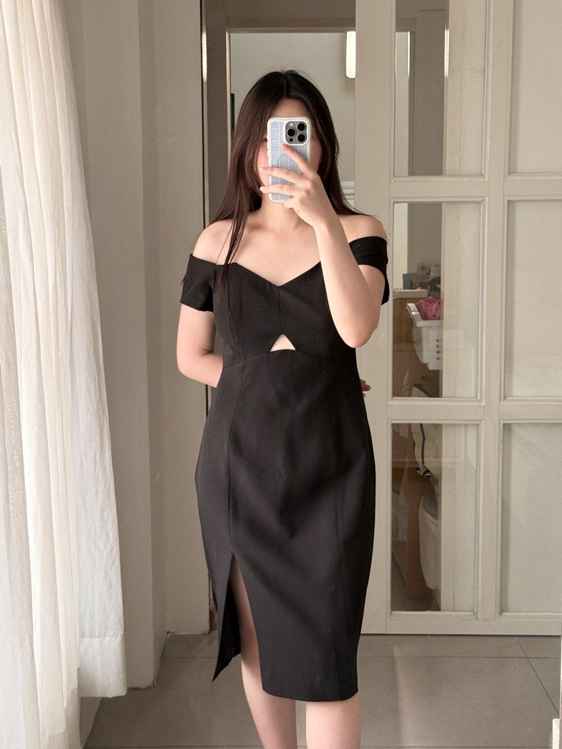Evernew Black Off-Shoulder Midi Dress (Category: Dresses) located in Manila. Submitted by curator.noona (Listing ID 1436852122, Image 1). Description: - Black off-shoulder midi dress - Keyhole detail at front - Fitted silhouette - Side slit - Suitable for special occasions - Smooth, likely woven fabric.