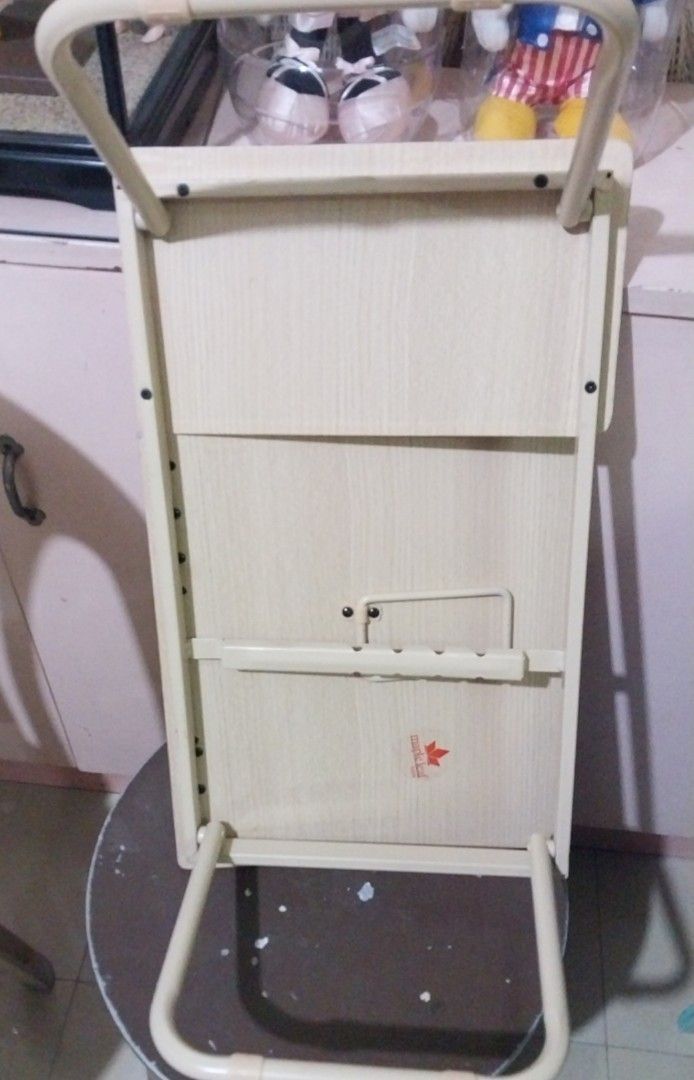 Foldable Laptop Table (Category: Tables & Sets) located in Pasig City. Submitted by carlosaini41 (Listing ID 1436901145, Image 3). Description: Foldable laptop table is perfect for working or studying in bed or on the couch. It features a heavy duty wood-grain finish and sturdy metal legs. The table folds flat for easy storage. It has a small, raised lip to prevent items from sliding off. The table also has a slot for a tablet or phone. -mabigat 