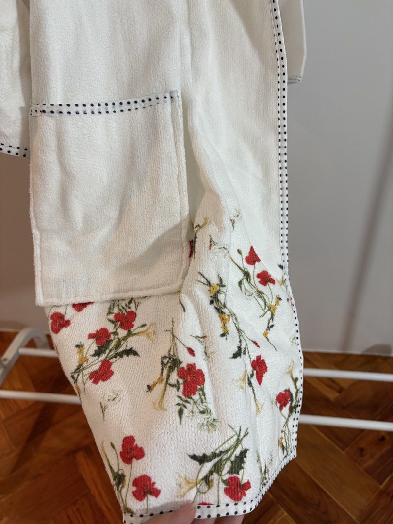 Francfranc White Floral Print Robe (Category: Undergarments & Loungewear) located in Muntinlupa City. Submitted by yuyubyyuka (Listing ID 1436948277, Image 3). Description: - Floral print edges and pockets - Shawl collar - Matching belt - Black stitching trim - Soft, absorbent material - Ideal for lounging or after shower With flaw as seen on photo.