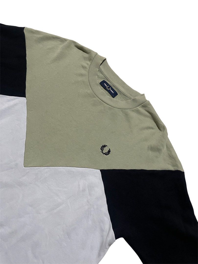 Fred Perry Colour Block Sweatshirt (Category: Coats, Jackets and Outerwear) located in Zamboanga. Submitted by yhooy (Listing ID 1437013354, Image 2). Description: - Fred Perry colour block sweatshirt - Features a classic crew neck - Iconic Laurel Wreath logo - Unique colour block design: black, green, and white - Made in China - Size tag visible in photos.