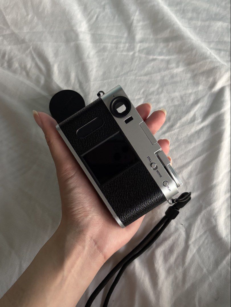 Fujifilm X-Half Digital Camera (Category: Cameras) located in Manila. Submitted by yurideclutter (Listing ID 1436935774, Image 2). Description: - Fujifilm X-Half digital camera - Black leather grip and silver top - Orig price when bought is 40K - touchscreen display - with box, straps, bag, etc. - Like new, used only a few times - No scratches whatsoever, well taken care of - Bluetooth - Includes lens cap and wrist strap - Features viewfinder and