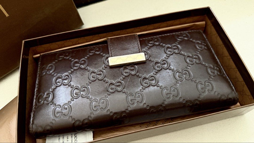 Gucci Brown Leather Wallet Original (Category: Luxury Bags & Wallets) located in Manila. Submitted by a_o_c (Listing ID 1436855961, Image 2). Description: - Authentic Gucci wallet - Brown leather with GG monogram - Includes original box and paperwork - Multiple card slots - Bill compartment - Gold-tone Gucci logo clasp - Made in Italy.