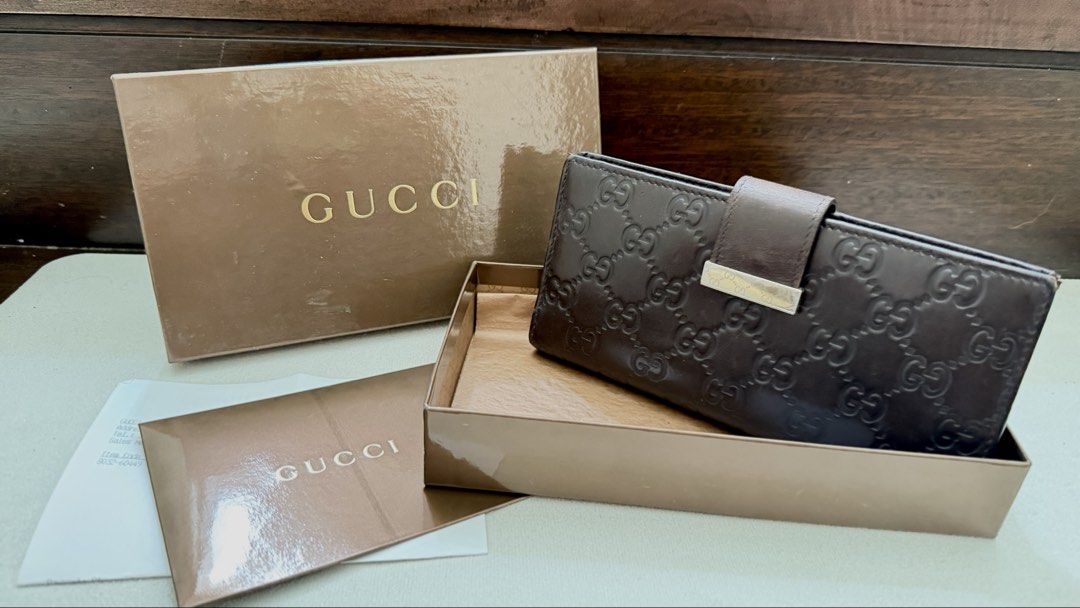 Gucci Brown Leather Wallet Original (Category: Luxury Bags & Wallets) located in Manila. Submitted by a_o_c (Listing ID 1436855961, Image 1). Description: - Authentic Gucci wallet - Brown leather with GG monogram - Includes original box and paperwork - Multiple card slots - Bill compartment - Gold-tone Gucci logo clasp - Made in Italy.
