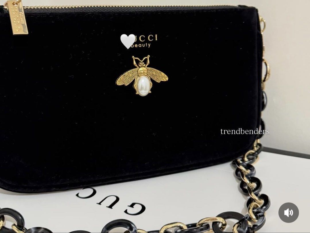 Gucci Velvet Bee Chain Bag (Category: Luxury Bags & Wallets) located in Iba. Submitted by geliqq (Listing ID 1436910398, Image 3). Description: - Black velvet handbag - Gold-tone chain strap - Decorative bee emblem - Gold zipper closure - Brand tag included - Black and gold chain links - Ideal for evening wear.