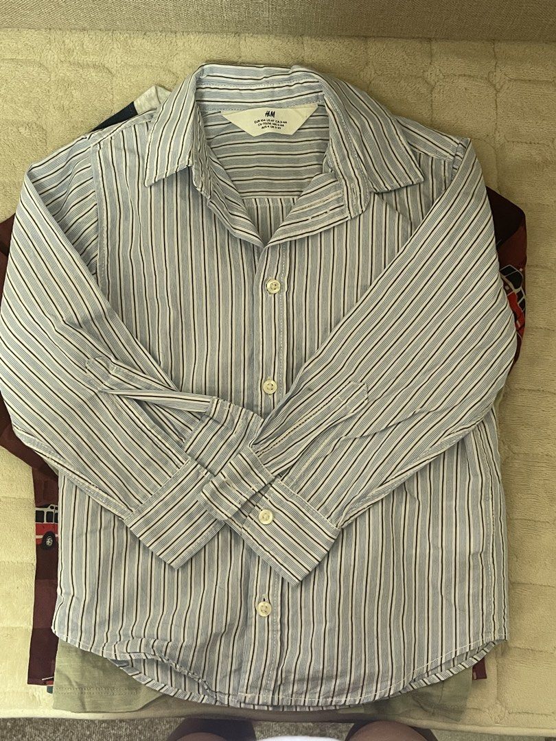H&M Striped Long Sleeve Shirt (Category: Longsleeves) located in San Pedro. Submitted by cchloepreloved (Listing ID 1436861063, Image 1). Description: - H&M long sleeve shirt - Classic striped design - Size: 4T - Collared neckline - Button-down closure - Long sleeves with buttoned cuffs - Lightweight fabric - Suitable for everyday wear.