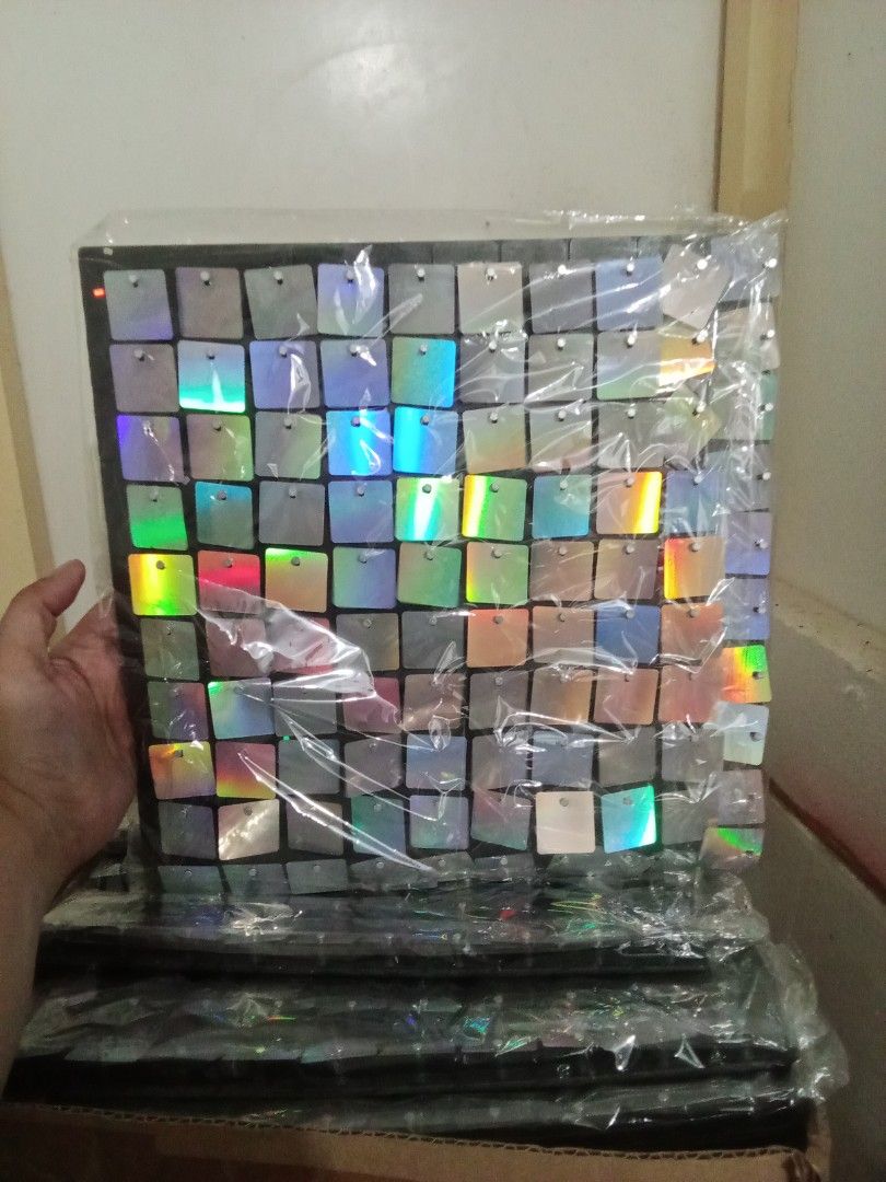 Iridescent Square Wall Panel (Category: Wall Decor) located in Valenzuela. Submitted by chris_cruz (Listing ID 1436921913, Image 1). Description: LOCATION: Deparo North Caloocan - New, unused wall panel. - Features iridescent square tiles. - Tiles reflect multiple colors. - Black backing. - Suitable for decorative use. - Wrapped in plastic. -35 pcs -PRICE: Negotiable.