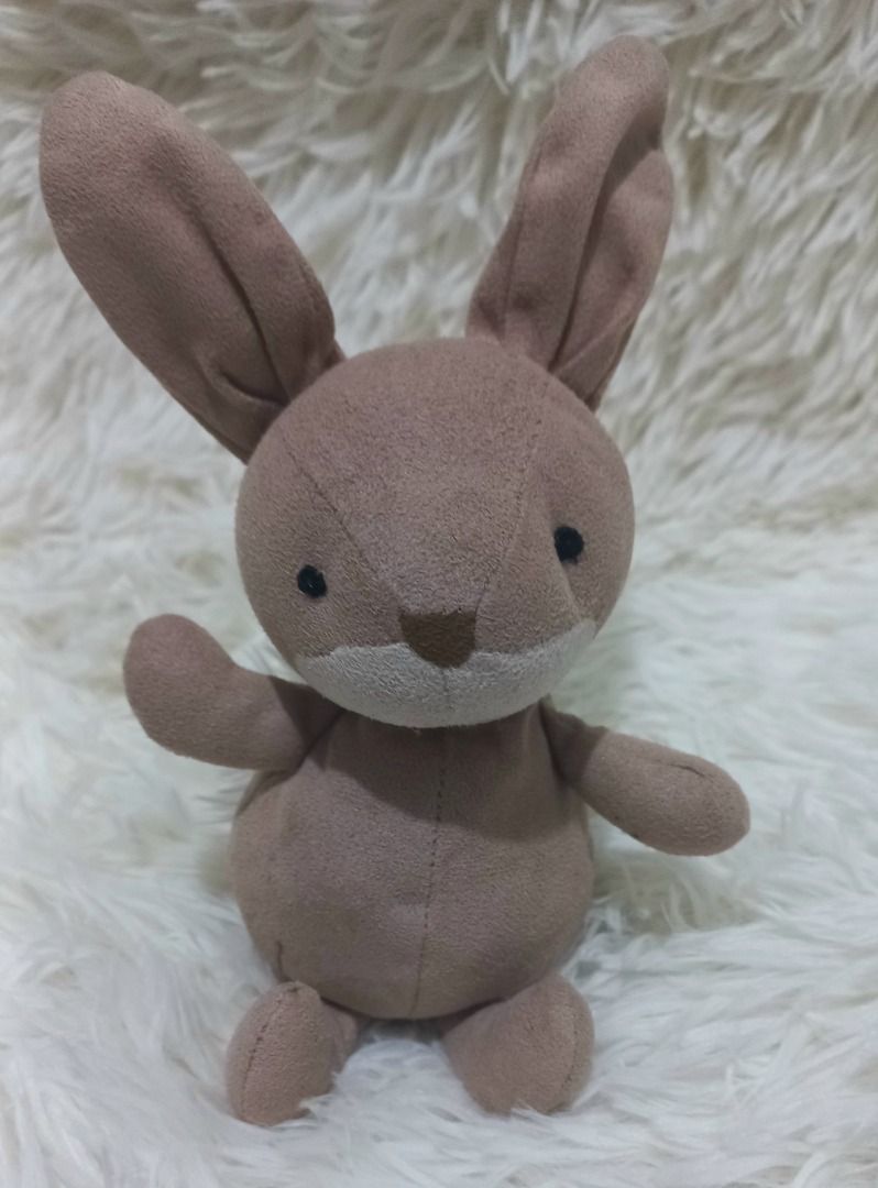 Jellycat Suedetta Bunny Plush Toy (Category: Plushies & Soft Toys) located in Taguig. Submitted by phlercollections (Listing ID 1436946468, Image 1). Description: - Adorable brown plush bunny - Soft and cuddly material - Features long ears and a cute face - Sitting position with outstretched arms - Ideal for children or collectors.