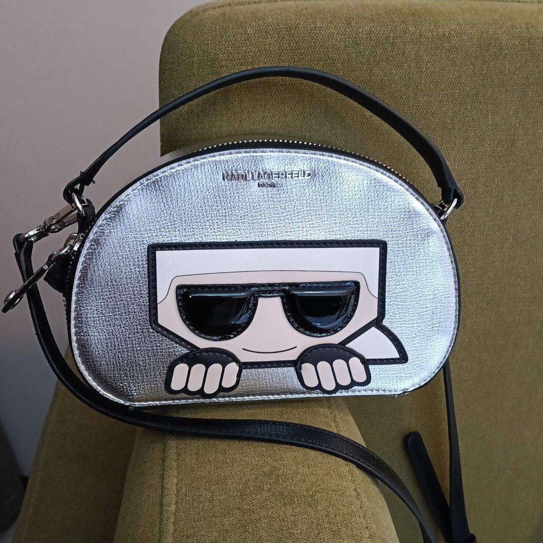 Karl Lagerfeld Silver Crossbody Bag (Category: Cross-body Bags) located in Mandaluyong City. Submitted by hailey143 (Listing ID 1436978017, Image 1). Description: - Karl Lagerfeld crossbody bag - Silver exterior with unique graphic design - Black strap and top handle - Black interior with small pocket - Comes with tags and a small card - Style: LH1EU9AI - MSRP: $198.00 - used once - RFS: 2 po pinadala sa akin 😊 .