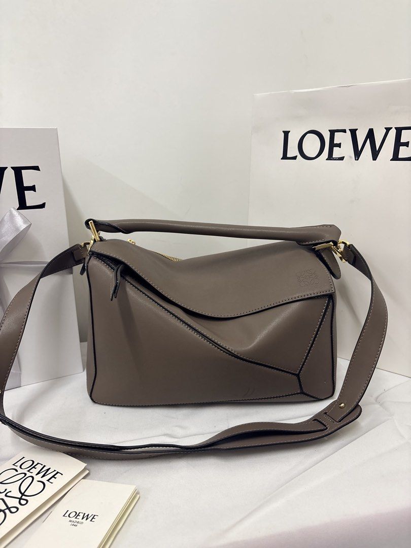 Loewe puzzle bag in taupe small (Category: Luxury Bags & Wallets) located in Quezon City. Submitted by herluxe_official (Listing ID 1436973805, Image 1). Description: .