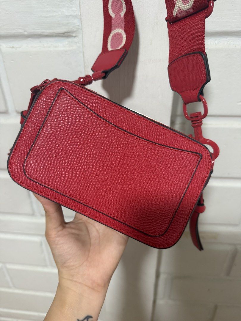 Marc Jacobs Red Crossbody Bag (Category: Luxury Bags & Wallets) located in Santa Rosa. Submitted by pamobs (Listing ID 1436899804, Image 2). Description: - Red Marc Jacobs crossbody bag - Detachable, patterned strap - Secure zip closure - Made of textured material - Vibrant red exterior - with minimal flaws on the side.