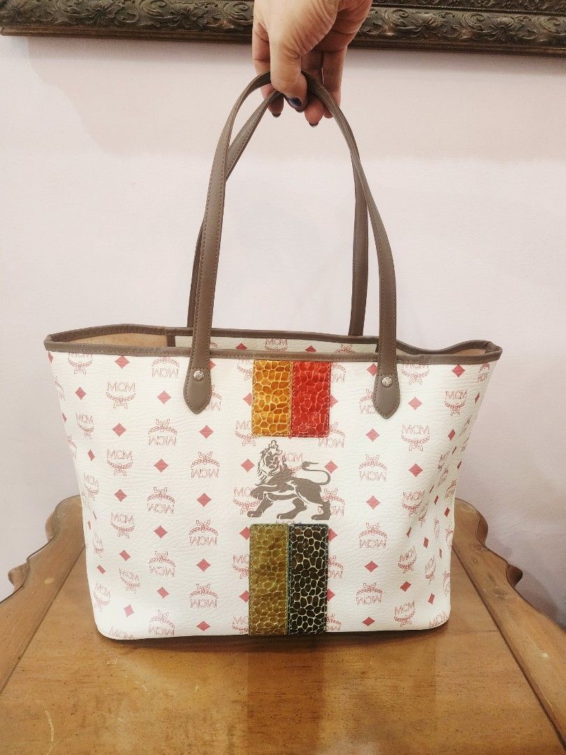 Mcm Lion Visetos Stripe Tote Bag (Category: Luxury Bags & Wallets) located in Valenzuela. Submitted by absolutelychick (Listing ID 1436829039, Image 1). Description: L 14" x W 6.25" x H 11.25" missing attached pouch may light na dumi sa inner lining and sa corners may ink mark po sa loob ng inner open pocket please check photos for reference jrs, lbc, j&t lalamove/grab ready.