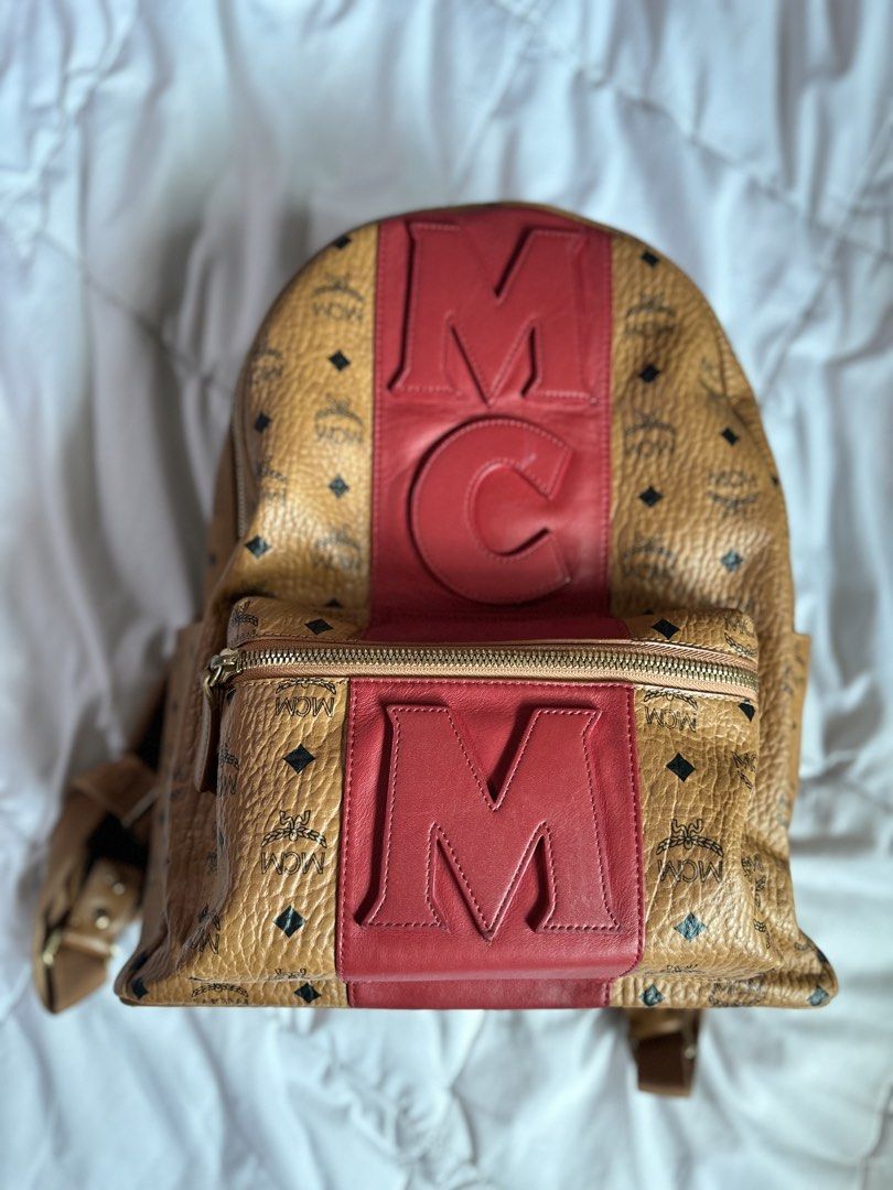 Mcm stark backpack (Category: Luxury Bags & Wallets) located in Quezon City. Submitted by cookieandmilky (Listing ID 1436917630, Image 2). Description: Selling my authentic MCM backpack in cognac visetos with red leather logo detailing. Very eye-catching and rare design. Perfect as a daily luxury bag or travel bag. Details: * Authentic * Price: ₱20,000 * Color: Cognac/Red * Spacious interior * Gold-tone hardware * Adjustable straps * Comes exactl
