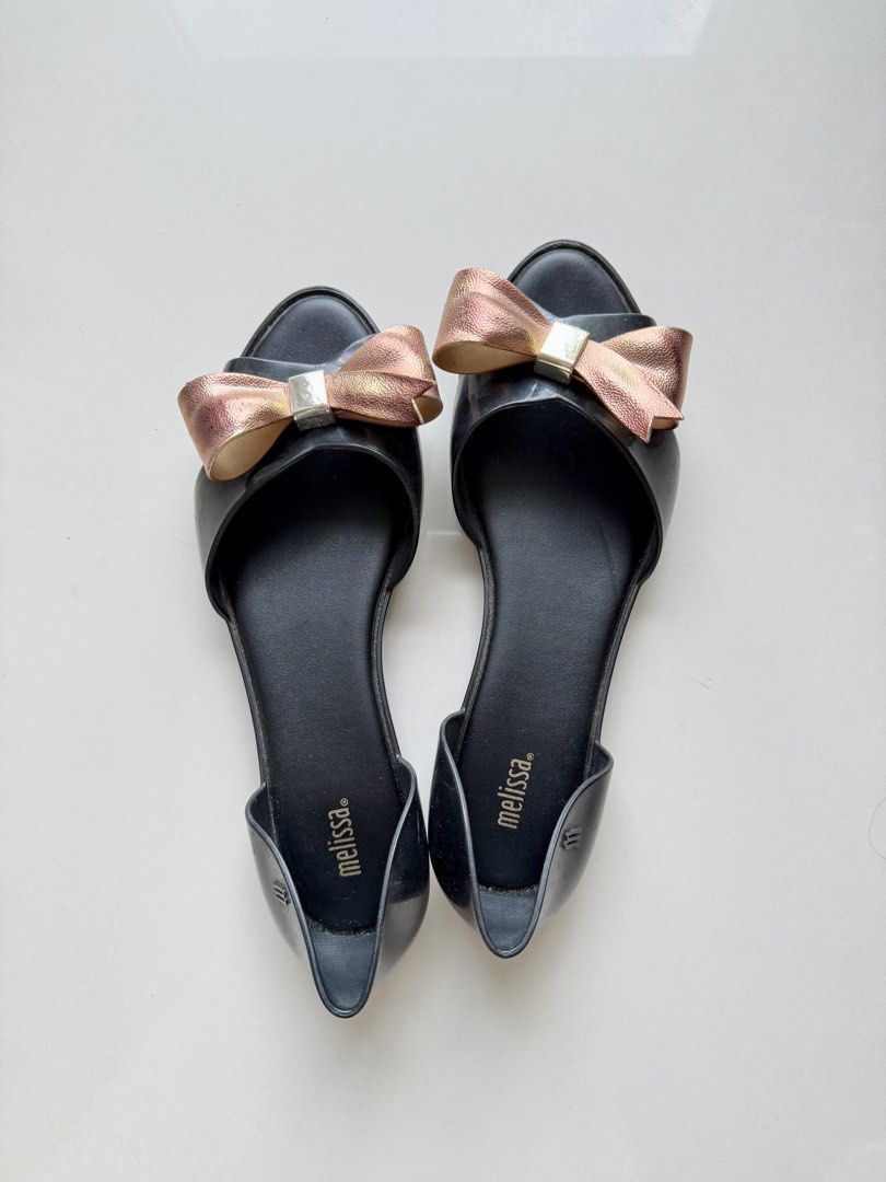 Melissa Seduction Bow Jelly Flats / Sandals (Category: Flats & Sandals) located in Taguig. Submitted by prebypat (Listing ID 1436913052, Image 1). Description: Preloved Melissa Seduction Bow Jelly Flats Size: US 8 Color: Black Detail: Metallic rose gold bow/ribbon Condition: Preloved, still in good condition Bought in-store for around ₱2,000–₱3,000 RFS: Decluttering.