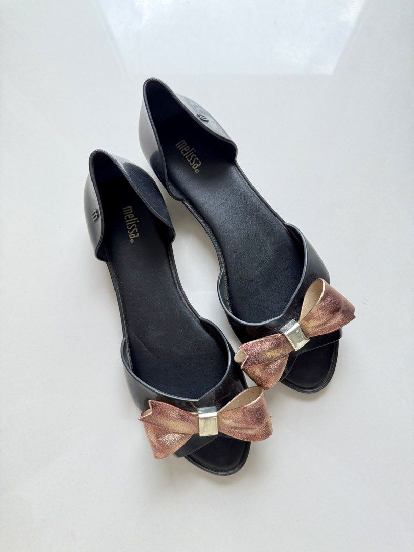 Melissa Seduction Bow Jelly Flats / Sandals (Category: Flats & Sandals) located in Taguig. Submitted by prebypat (Listing ID 1436913052, Image 2). Description: Preloved Melissa Seduction Bow Jelly Flats Size: US 8 Color: Black Detail: Metallic rose gold bow/ribbon Condition: Preloved, still in good condition Bought in-store for around ₱2,000–₱3,000 RFS: Decluttering.