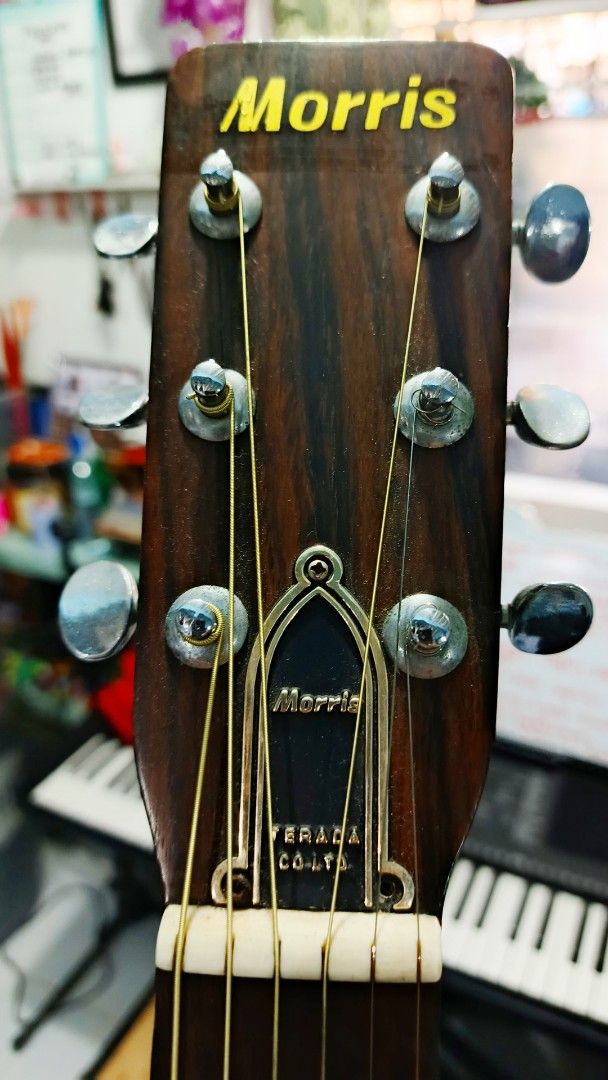 Morris Acoustic Guitar (Category: Musical Instruments) located in Imus. Submitted by fierceflower_74db29 (Listing ID 1436878485, Image 3). Description: - Vintage Morris acoustic guitar - Natural wood finish - Black pickguard - Morris logo on headstock - Six strings - Brand and model information visible inside the soundhole.