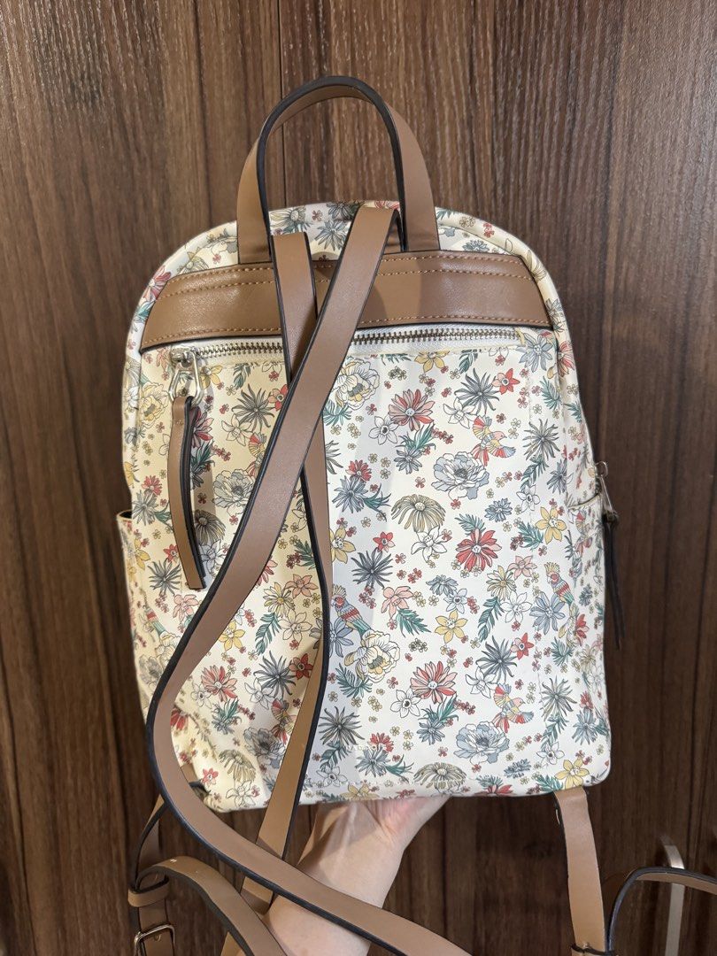Parfois - Floral Print Backpack (Category: Backpacks) located in Mandaluyong City. Submitted by jayannt (Listing ID 1436924739, Image 2). Description: - Floral print design - Front zippered pocket - Two side pockets - Brown straps and top handle - Double zipper closure - Made of durable material.
