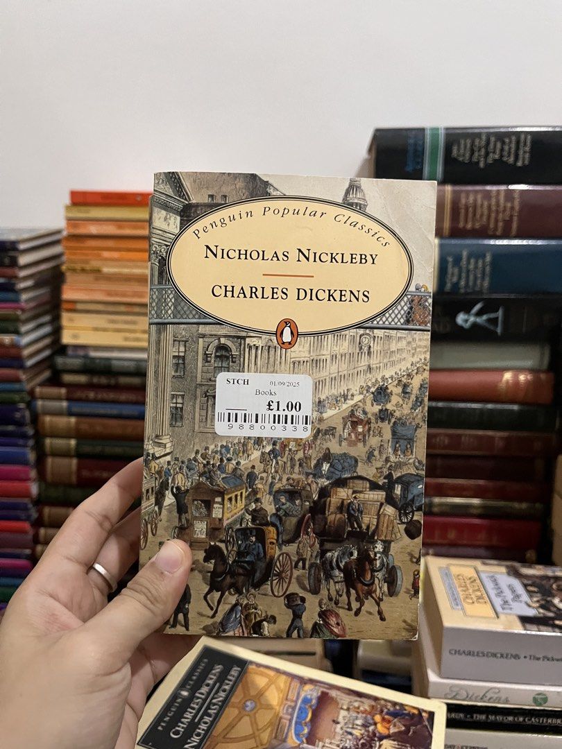 Penguin Popular Classics Nicholas Nickleby by Charles Dickens (Category: Storybooks) located in Maragondon. Submitted by quilljoylibrary (Listing ID 1436979641, Image 1). Description: - Nicholas Nickleby by Charles Dickens - Penguin Popular Classics edition - Cover illustration: Bustling street scene - Original price: £1.00 - From a collection of classic literature.