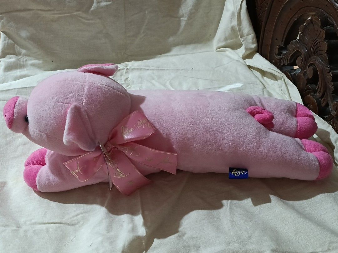 Pink Pig Stuffed Toy Blue Magic (Category: Plushies & Soft Toys) located in Quezon City. Submitted by mhiemime (Listing ID 1436827877, Image 2). Description: - Adorable pink pig plush toy - Features a cute pink bow and small ears - Soft, plush texture - Lying down position - Small black eyes and pink snout.